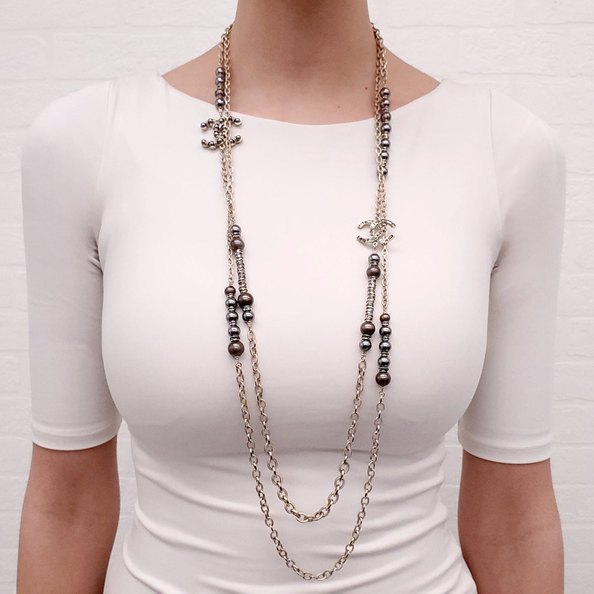 CHANEL GOLD, BRONZE, AND GREY LAYERED PEARL NECKLACE WITH CRYSTAL LOGOS