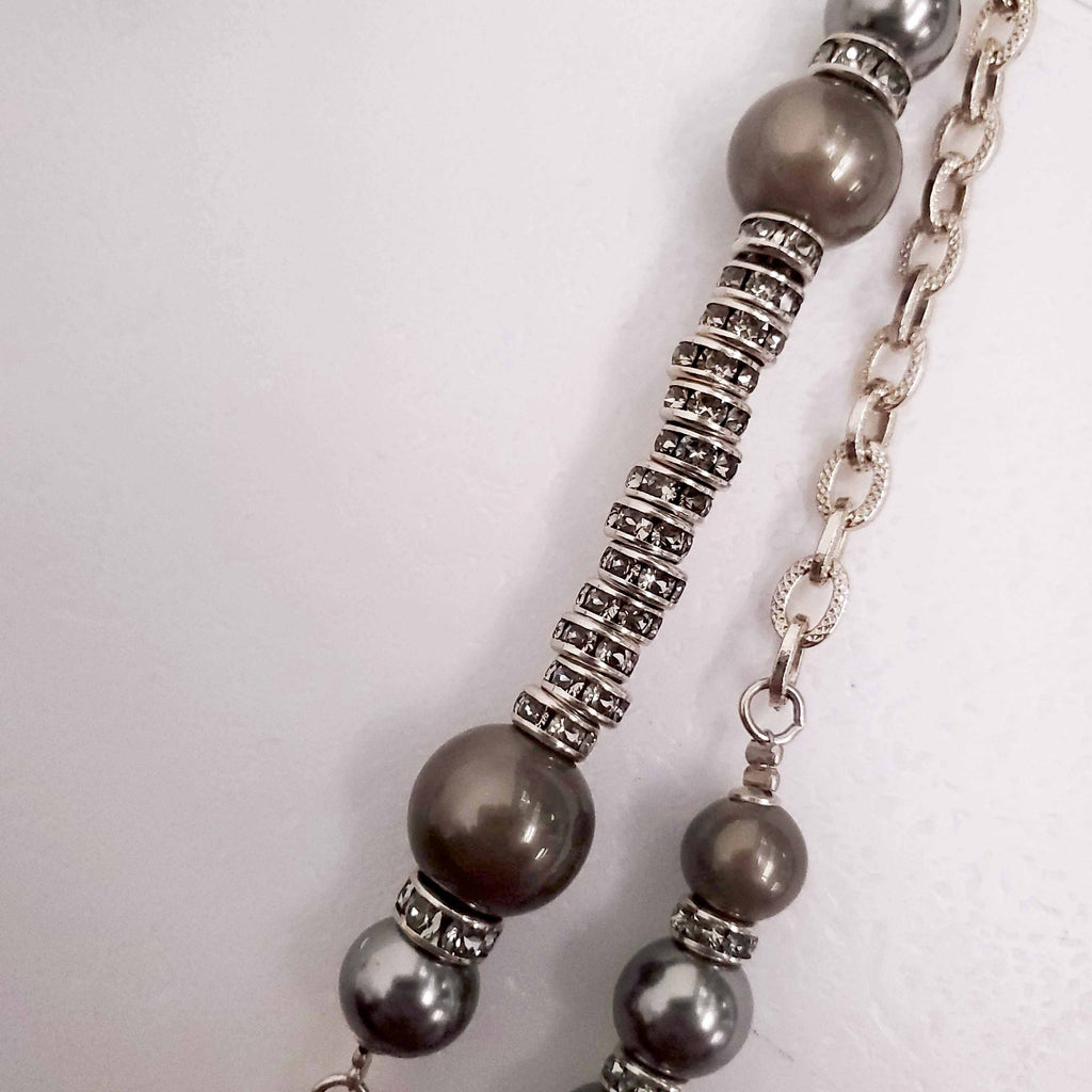 CHANEL GOLD, BRONZE, AND GREY LAYERED PEARL NECKLACE WITH CRYSTAL LOGOS